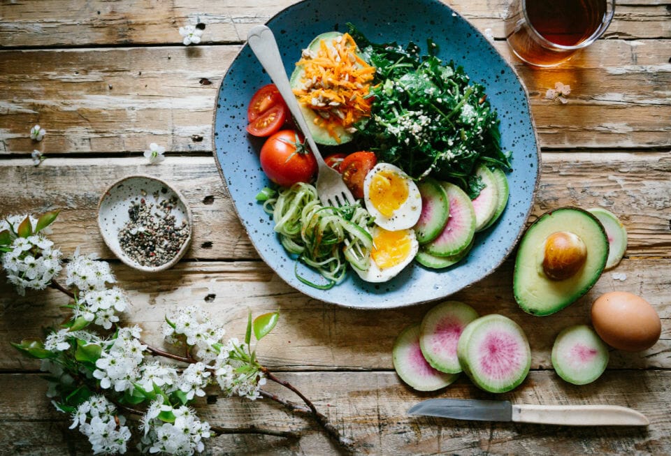 A plate full of healthy food on a wood table to help ease perimenopause or menopause symptoms